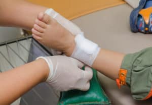 child's injured leg being treated by a nurse