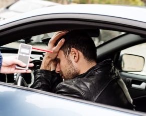 man being asked to use a breathalyzer in Indiana