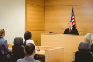 Judge listening to plaintiff's lawyer in truck accident case asking for punitive damages.