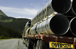 oversize load truck driving through mountains