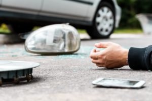 fatal car accident aftermath - crashed car and dead man