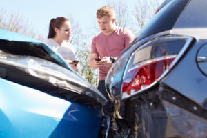 accident victims exchanging insurance information