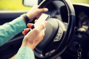man distracted by cell phone while driving