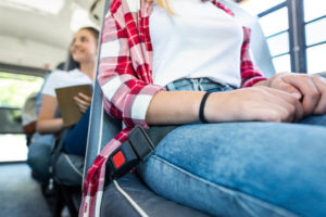 students with seat belts in a school bus