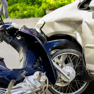 a motorcycle crashed into the side of a car.