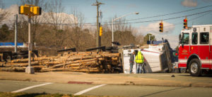 overturned log truck after a motor vehicle collision