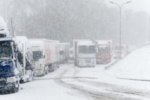 trucks parked on a highway due to bad weather