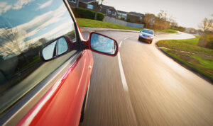 two cars getting ready to pass each other on the road