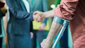 injured victim shaking hands with a lawyer