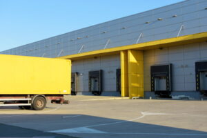 Truck trailer standing close to warehouse